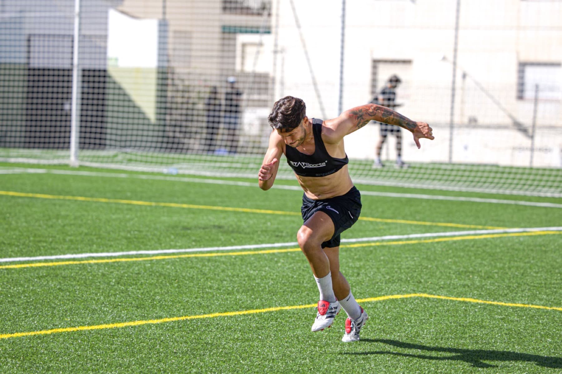 Football player sprinting forward on the field